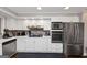 Updated kitchen with stainless steel appliances, white cabinetry, and modern backsplash at 6 Alston Ne Pl, Atlanta, GA 30324