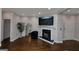 Bright living room with fireplace, TV, hardwood floors and large mirror that add a modern touch to the space at 6 Alston Ne Pl, Atlanta, GA 30324