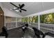 Covered back porch features dark floors, neutral colored screens, ceiling fan, and view of trees at 6 Alston Ne Pl, Atlanta, GA 30324