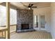 Covered porch with wood floors and a stone fireplace and a ceiling fan, perfect for enjoying the outdoors at 5480 Two Hills Dr # 31, Fairburn, GA 30213