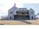 View of the home's rear exterior with a large deck, sizable windows, and an expansive yard at 5480 Two Hills Dr # 31, Fairburn, GA 30213