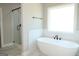 Modern bathroom features a standalone tub, glass shower, and natural light from the large window at 5480 Two Hills Dr # 31, Fairburn, GA 30213