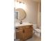 Bathroom featuring round mirror, wooden cabinets, modern sink and toilet with a shower/bathtub combo at 5480 Two Hills Dr # 31, Fairburn, GA 30213