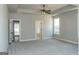 Large primary bedroom features neutral walls, carpet, walk in closet, and views through bright windows at 5480 Two Hills Dr # 31, Fairburn, GA 30213