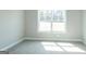 Bedroom featuring neutral walls, carpet, view to exterior, and bright natural light at 5480 Two Hills Dr # 31, Fairburn, GA 30213