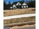 New construction home featuring stone accents and a well-manicured lawn in a suburban community at 5480 Two Hills Dr # 31, Fairburn, GA 30213