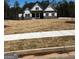 New construction home featuring stone accents and a well-manicured lawn in a suburban community at 5480 Two Hills Dr # 31, Fairburn, GA 30213
