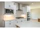 This kitchen features stainless appliances including a built in microwave and oven, white cabinets, and marble countertops at 5480 Two Hills Dr # 31, Fairburn, GA 30213