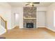 Cozy living room featuring a stone fireplace, hardwood floors, and a ceiling fan at 5480 Two Hills Dr # 31, Fairburn, GA 30213