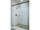 Glass walk-in shower featuring detailed tile, modern shower head, and built in shelf at 5480 Two Hills Dr # 31, Fairburn, GA 30213