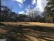 Large backyard featuring home, gazebo, and mature trees at 55 Gill Ln, Stockbridge, GA 30281