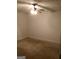 Empty carpeted basement room with white walls and ceiling fan and light at 55 Gill Ln, Stockbridge, GA 30281