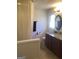 Bathroom with a granite vanity, dark wood cabinets, and neutral color walls at 55 Gill Ln, Stockbridge, GA 30281