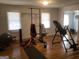Exercise room with hardwood floors, windows and various pieces of workout equipment at 55 Gill Ln, Stockbridge, GA 30281
