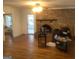 Living room with hardwood floors, fireplace, and doorway leading to another room at 55 Gill Ln, Stockbridge, GA 30281
