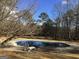 Beautiful in-ground pool with surrounding patio and lounge chair at 55 Gill Ln, Stockbridge, GA 30281