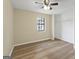 Bedroom with closet, window, ceiling fan and wood-look floors at 108 Adrian Dr, Stockbridge, GA 30281