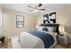 Bright bedroom with wood flooring, ceiling fan, and large window at 108 Adrian Dr, Stockbridge, GA 30281