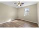 Bedroom with window, ceiling fan and wood-look floors at 108 Adrian Dr, Stockbridge, GA 30281