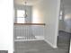 Open staircase with white wooden spindles, wooden handrail, and light-colored flooring leading to the upper level at 3700 Newhalem Sw St, Atlanta, GA 30331