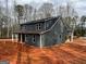 A new two-story home with gray siding, black roof, and white trim showcases modern farmhouse charm at 1563 South Bethany Rd, Mcdonough, GA 30252