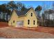 Side view of new construction home showcasing yellow siding and gray roof at 1563 South Bethany Rd, Mcdonough, GA 30252