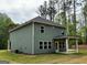 Exterior back view of house, showcasing a covered patio and manicured lawn, ideal for relaxation and outdoor activities at 1555 South Bethany Rd, Locust Grove, GA 30248