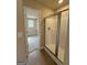 Bathroom featuring a glass-enclosed shower and an open door to the walk-in closet at 1555 South Bethany Rd, Locust Grove, GA 30248
