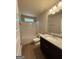 Bright bathroom with tub-shower combo, granite vanity, and wood-look floor at 1555 South Bethany Rd, Locust Grove, GA 30248