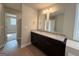 Well-lit bathroom featuring a double vanity with granite counters and wood-look flooring at 1555 South Bethany Rd, Locust Grove, GA 30248