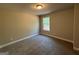 Bedroom featuring a window that lets in natural light, enhancing the neutral color scheme at 1555 South Bethany Rd, Locust Grove, GA 30248