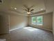 Bedroom featuring a tray ceiling with ceiling fan, fresh paint, and plush carpeting and natural light at 1555 South Bethany Rd, Locust Grove, GA 30248