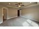 Bedroom featuring a tray ceiling with ceiling fan, fresh paint, and plush carpeting at 1555 South Bethany Rd, Locust Grove, GA 30248