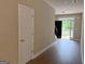 A bright foyer with wood floors, a white door, and natural light from the front entrance at 1555 South Bethany Rd, Locust Grove, GA 30248