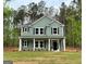 Two-story home featuring gray siding, black shutters, white trim, and a well-manicured lawn at 1555 South Bethany Rd, Locust Grove, GA 30248
