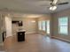 Open kitchen with dark cabinets, center island and a view into the Gathering room at 1555 South Bethany Rd, Locust Grove, GA 30248