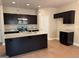 Kitchen featuring dark cabinets, an island, granite countertops and pendant lighting at 1555 South Bethany Rd, Locust Grove, GA 30248