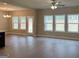 Open concept living space with lots of natural light, wood floors, and neutral walls at 1555 South Bethany Rd, Locust Grove, GA 30248