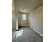 Walk-in closet with carpet and metal shelving with window allowing natural light at 1555 South Bethany Rd, Locust Grove, GA 30248