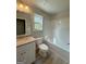 Bathroom featuring a shower and tub combo, vanity with granite counter, and wood look floors at 1547 South Bethany Rd, Locust Grove, GA 30248