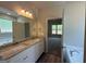 Bathroom with a double sink vanity and granite countertops adjacent to the bedroom at 1547 South Bethany Rd, Locust Grove, GA 30248