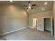 Large bedroom with neutral walls, carpet flooring, ceiling fan, and ensuite bathroom at 1547 South Bethany Rd, Locust Grove, GA 30248
