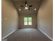 Bedroom with neutral walls, carpet flooring, and large window with view of trees at 1547 South Bethany Rd, Locust Grove, GA 30248