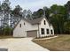 Two-story home with a two-car garage and manicured lawn at 1547 South Bethany Rd, Locust Grove, GA 30248