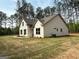 Two-story home featuring white siding, dark trim, and a well-manicured lawn at 1547 South Bethany Rd, Locust Grove, GA 30248