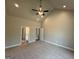 Spacious main bedroom with vaulted ceilings, ceiling fan, carpet flooring, and ensuite bathroom at 1547 South Bethany Rd, Locust Grove, GA 30248