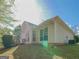 Back exterior view of the home showing large windows, the yard, and the siding at 334 Royal Crescent Way, Stockbridge, GA 30281