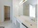 Bathroom featuring double sinks, a large mirror, and a walk-in closet at 334 Royal Crescent Way, Stockbridge, GA 30281