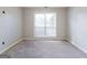 Bedroom featuring neutral carpet and a large window at 334 Royal Crescent Way, Stockbridge, GA 30281