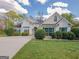 Charming single-story home with stucco exterior, landscaped yard, and well manicured green bushes at 334 Royal Crescent Way, Stockbridge, GA 30281